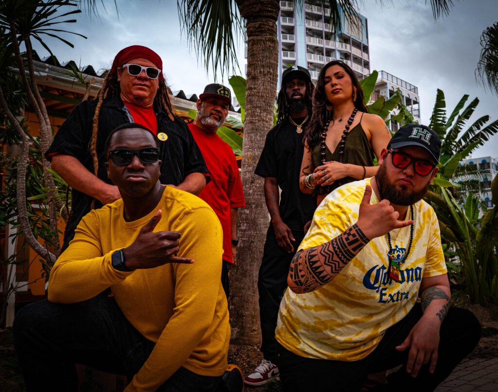 Shima Vibez band members posing together outdoors in Okinawa, Japan